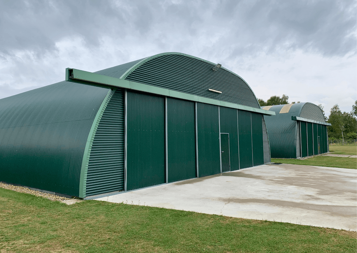 3047 - R15 - Multiple Romney hangars at an airfield