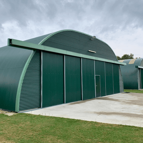3047 - R15 - Multiple Romney hangars at an airfield